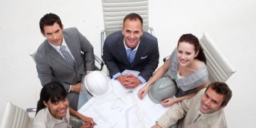 high angle architects working with plans